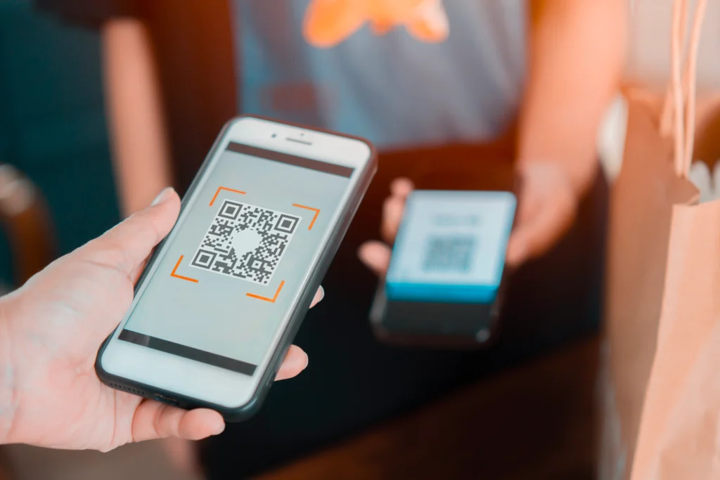 Customer scanning a QR code to complete an online payment using iPay digital payment solution